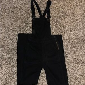 Madewell black denim overalls, frayed hem.